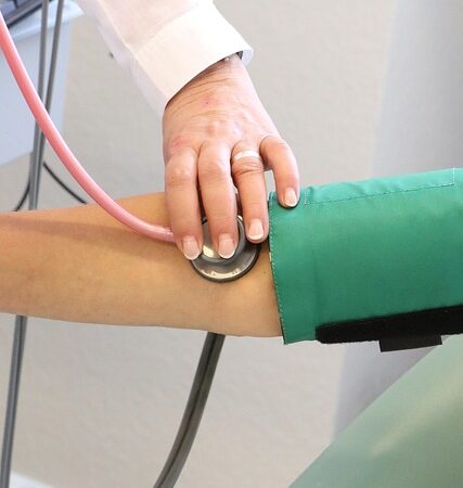 Doctor taking blood pressure with stethoscope and cuff — Types of Vertigo | Dr. Prateek Porwal, ENT
