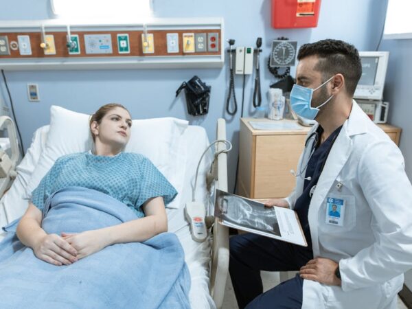 Doctor discusses medical results with patient in hospital bed — Bangalore Maneuver | Dr. Prateek Porwal, ENT