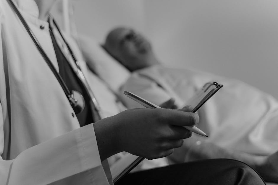 Doctor with stethoscope taking notes by patient in bed — बैंगलोर मैनुवर | Dr. Prateek Porwal, ENT