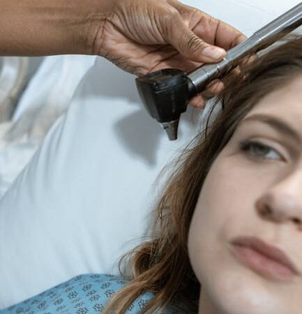 Doctor examining patient's ear with otoscope in medical setting — BPPV ચક્કર | Dr. Prateek Porwal, ENT