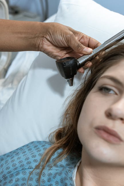 Doctor examining patient's ear with otoscope in medical setting — BPPV ચક્કર | Dr. Prateek Porwal, ENT