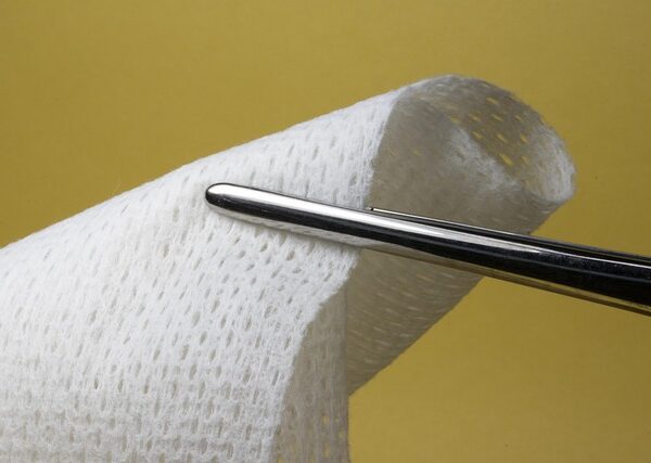 Surgical gauze held by forceps against a yellow background — bppv recurrence | Dr. Prateek Porwal, ENT