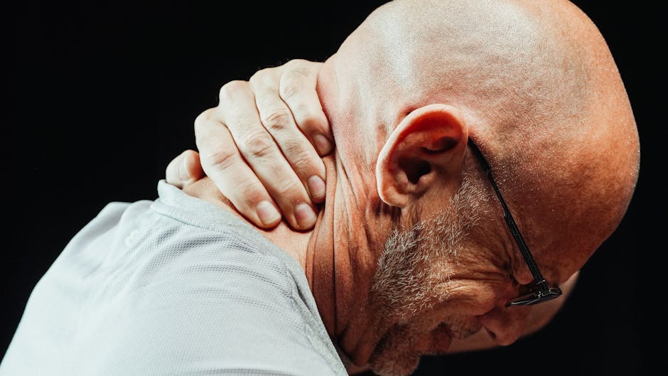 Man holding his neck, showing pain or discomfort — बुजुर्गों में गिरने का डर और चक्कर | Dr. Prateek Porwal, ENT