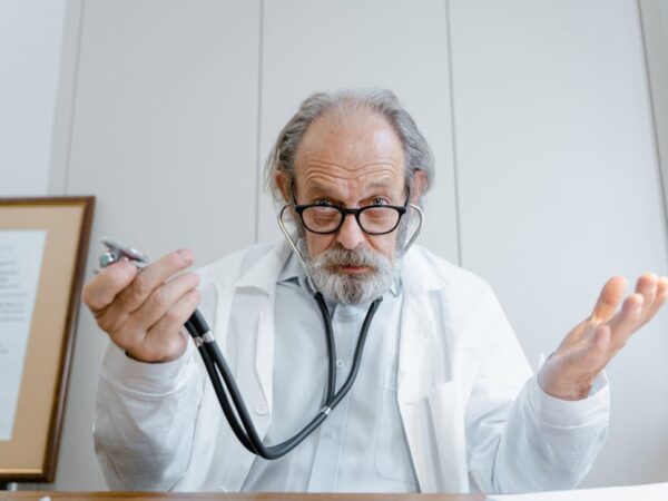 Doctor with stethoscope looking confused and gesturing — बुजुर्गों में चक्कर | Dr. Prateek Porwal, ENT