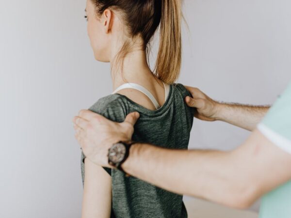 Hands on patient's shoulders and neck for examination or therapy — can vestibular neuritis come | Dr. Prateek Porwal, ENT