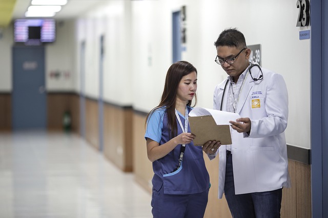 Doctor and nurse discussing medical chart in hospital hallway — चक्कर का इलाज | Dr. Prateek Porwal, ENT