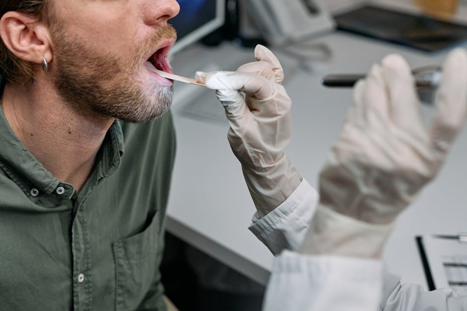 Doctor examining patient's throat with a tongue depressor — चक्कर आले तर डॉक्टरांना कधी भेटावे | Dr. Prateek Porwal, ENT