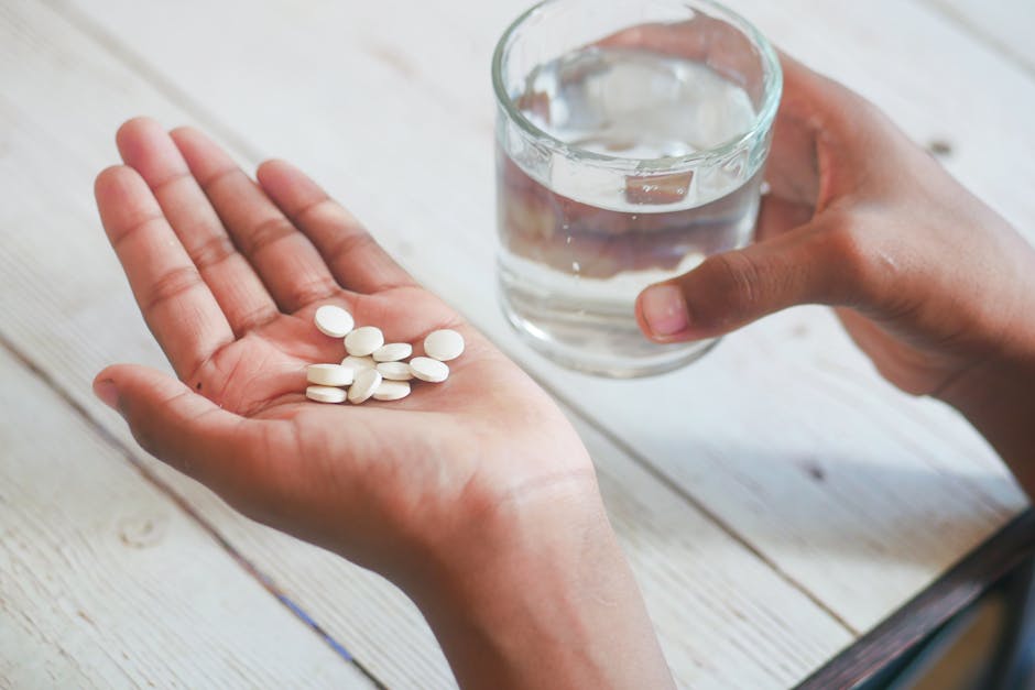 Hand holding pills and glass of water for medication — चक्कर में खान-पान | Dr. Prateek Porwal, ENT