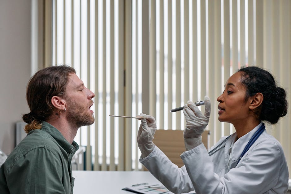 Doctor examines patient's throat with tongue depressor and light — चक्कर येण्याची ७ प्रमुख कारणे | Dr. Prateek Porwal, ENT