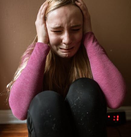 Young girl crying with hands over ears, distressed — चिंता आणि चक्कर | Dr. Prateek Porwal, ENT