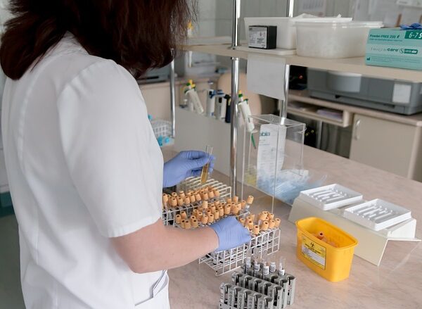 Medical professional handling test tubes in a laboratory setting — Epley Maneuver ઘરે કેવી રીતે કર… | Dr. Prateek Porwal, ENT