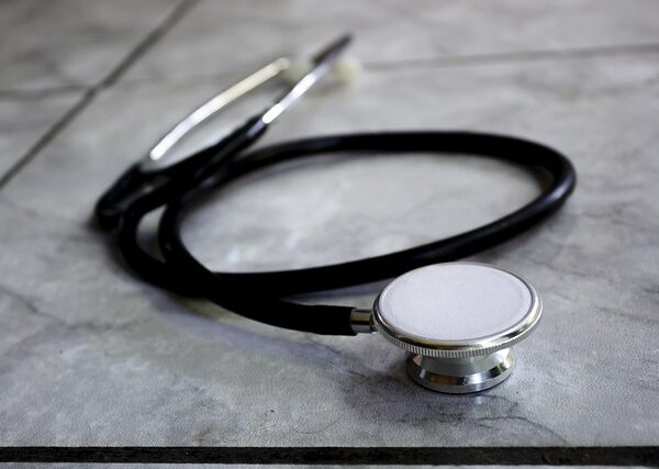 A black stethoscope lies on a tiled surface — गर्मी और बरसात में चक्कर | Dr. Prateek Porwal, ENT