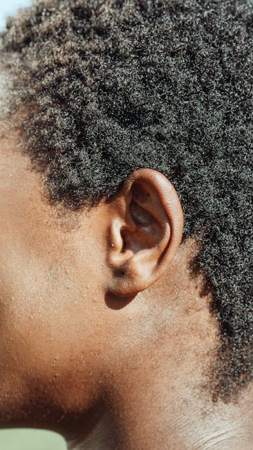 Close-up profile of a human ear with dark curly hair — gaze stabilization exercises for vertigo | Dr. Prateek Porwal, ENT