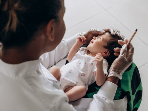 Doctor examines a baby's ear with a tool — গর্ভাবস্থায় মাথা ঘোরা | Dr. Prateek Porwal, ENT