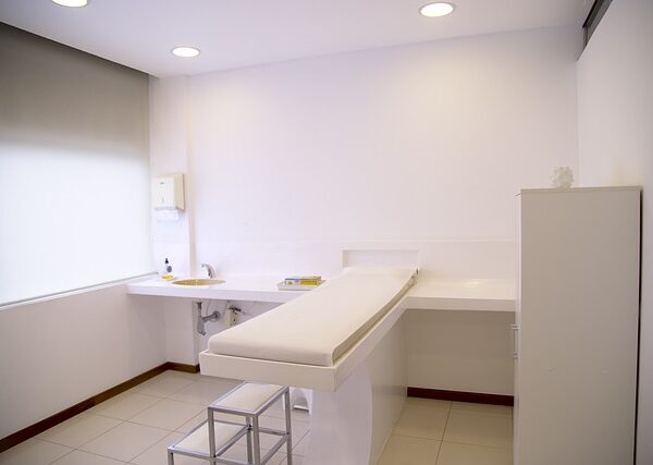A clean examination room with a bed and sink — half somersault maneuver | Dr. Prateek Porwal, ENT