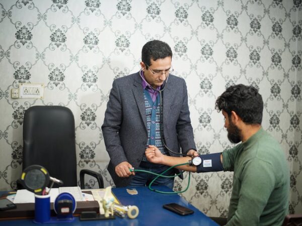 Doctor checks patient's blood pressure in a clinic setting — hints exam | Dr. Prateek Porwal, ENT