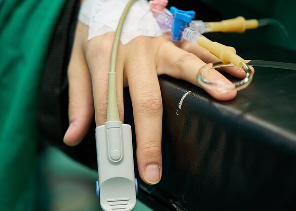 Patient's hand with pulse oximeter and IV lines — vertigo history | Dr. Prateek Porwal, ENT