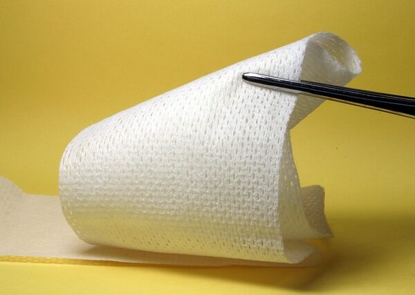 Medical gauze roll held by forceps against yellow background — মাথা ঘোরায় কখন | Dr. Prateek Porwal, ENT