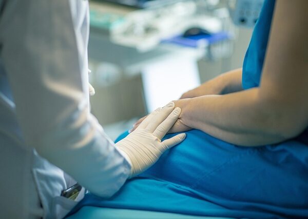 Doctor in gloves comforting patient with hand on arm — মেনিয়ার রোগ | Dr. Prateek Porwal, ENT