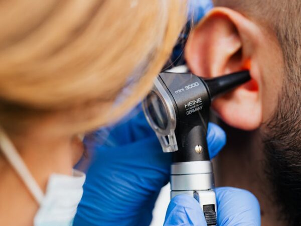 Doctor examining ear canal with otoscope — online vertigo consultation | Dr. Prateek Porwal, ENT