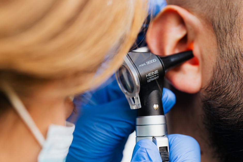Doctor examining ear canal with otoscope — online vertigo consultation | Dr. Prateek Porwal, ENT