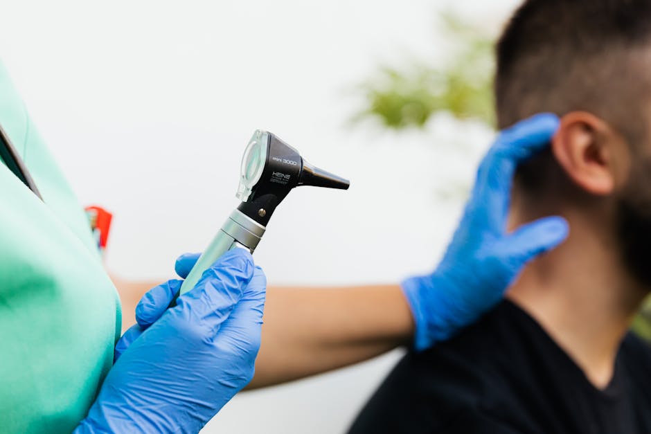 Doctor using otoscope to examine patient's ear — posterior canal bppv | Dr. Prateek Porwal, ENT