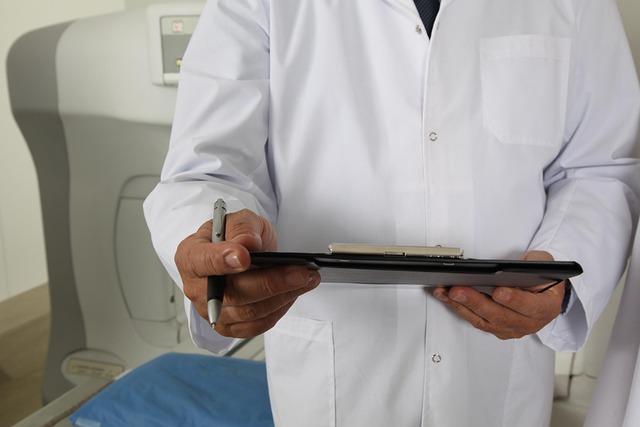 Doctor in white coat holding clipboard and pen near medical equipment — ramsay hunt syndrome | Dr. Prateek Porwal, ENT