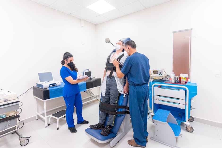 Patient in chair with medical equipment, staff observing — સમતુલા કસરતો | Dr. Prateek Porwal, ENT