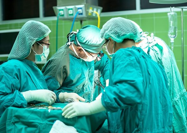 Surgeons in operating room performing surgery with medical instruments — Vertigo Specialist Bangal… | Dr. Prateek Porwal, ENT