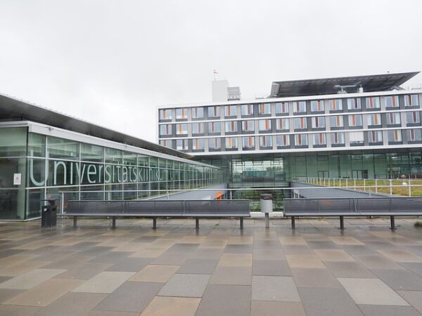 Exterior of a modern university hospital building with benches — Vertigo Doctor in Farrukhabad | Dr. Prateek Porwal, ENT