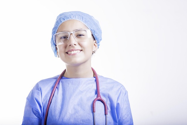 Smiling doctor in surgical attire with stethoscope and glasses — Vertigo Specialist Hyderabad | Dr. Prateek Porwal, ENT