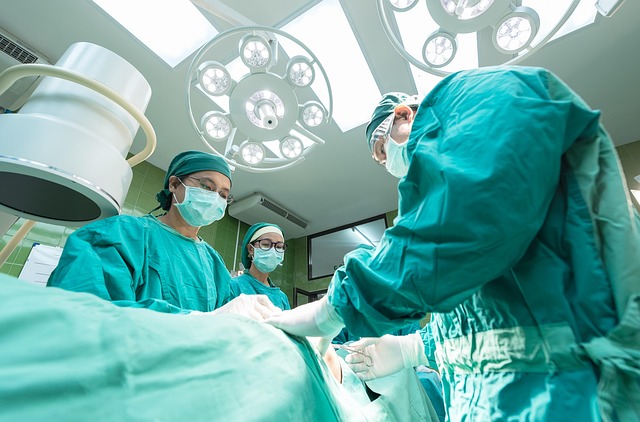 Surgeons in operating room performing surgery with surgical lights — Vertigo Specialist Kolkata | Dr. Prateek Porwal, ENT