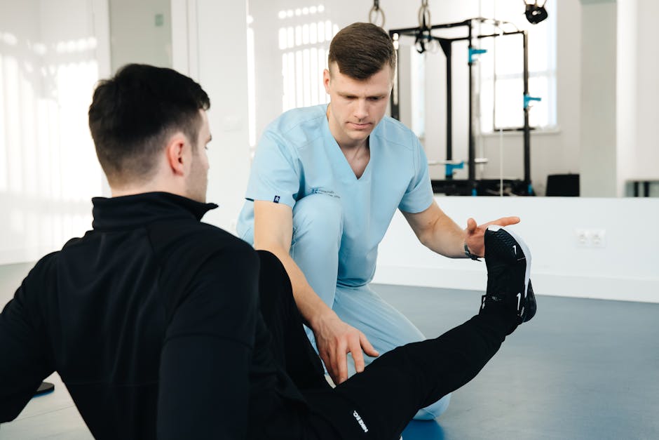 Doctor assisting patient with leg exercise in a clinic — Vertigo Doctor in Meerut | Dr. Prateek Porwal, ENT