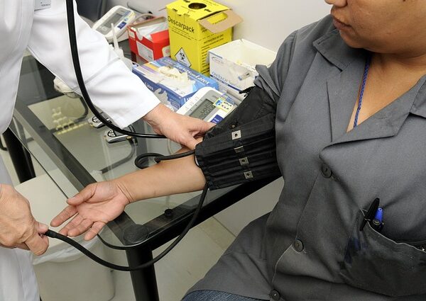 Doctor taking patient's blood pressure with a cuff — vertigo consultation pune | Dr. Prateek Porwal, ENT