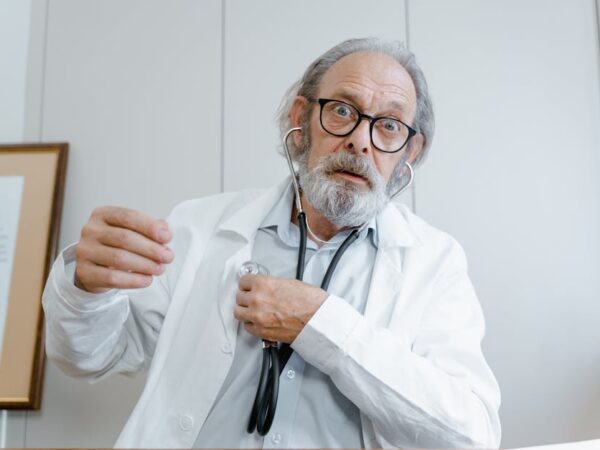Doctor with stethoscope looking surprised at camera — vertigo meaning in hindi | Dr. Prateek Porwal, ENT