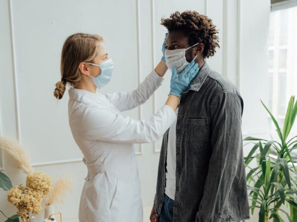 Doctor adjusting patient's face mask for protection — Vertigo specialist for Chennai patients | Dr. Prateek Porwal, ENT