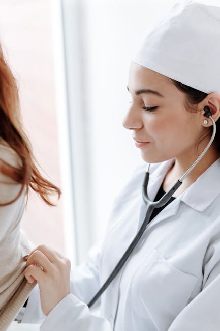 Doctor using stethoscope on a patient's chest — Vertigo specialist for Delhi patients | Dr. Prateek Porwal, ENT
