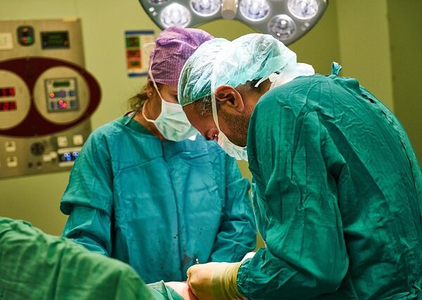 Surgeons in operating room performing a procedure with medical equipment — Vertigo Doctor in Lakhi… | Dr. Prateek Porwal, ENT
