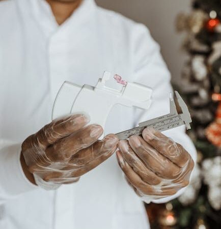 Person in gloves holding medical caliper and device — vertigo specialist Lucknow | Dr. Prateek Porwal, ENT