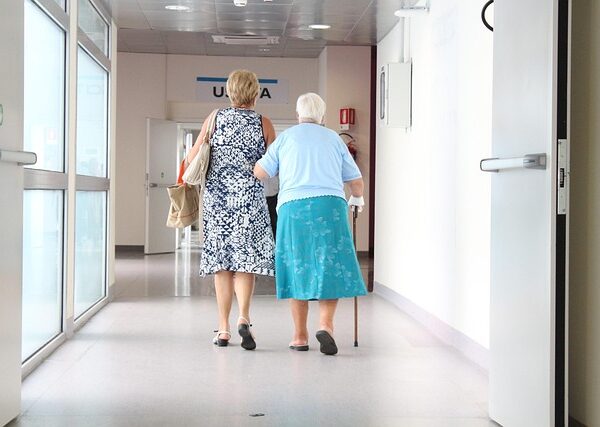 Two women walking down a hospital hallway — Vertigo Doctor in Moradabad | Dr. Prateek Porwal, ENT