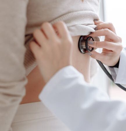 Doctor using stethoscope to examine patient's back — Vertigo specialist for Pune patients | Dr. Prateek Porwal, ENT