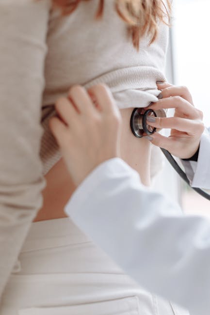 Doctor using stethoscope to examine patient's back — Vertigo specialist for Pune patients | Dr. Prateek Porwal, ENT