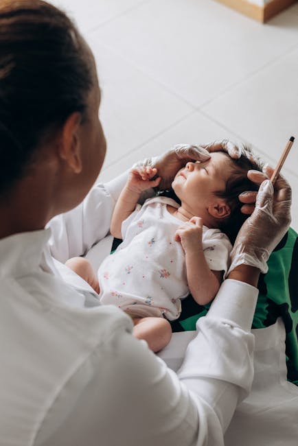Doctor examines baby's ear with gloved hands and tool — vestibular migraine in children | Dr. Prateek Porwal, ENT