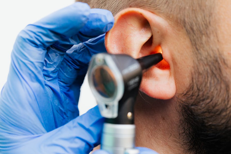 Doctor examining ear canal with otoscope and blue gloves — vestibular rehabilitation after neuritis | Dr. Prateek Porwal, ENT