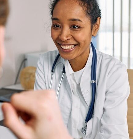 Doctor in white coat smiling at patient during consultation — viral vs bacterial labyrinthitis | Dr. Prateek Porwal, ENT