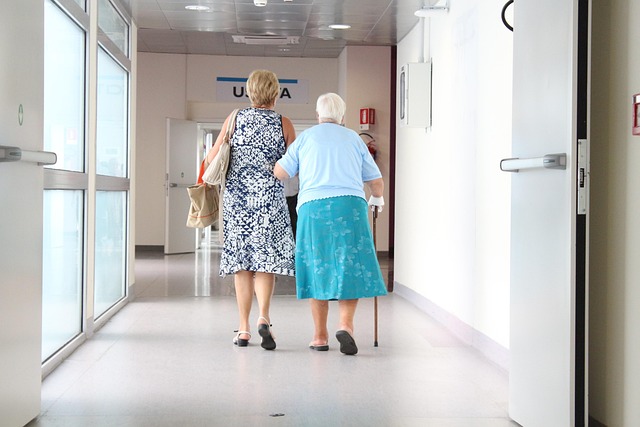 Two women walking down a hospital hallway — ઘરડા માણસોને ચક્કર અને પડી જવાનો ભય | Dr. Prateek Porwal, ENT
