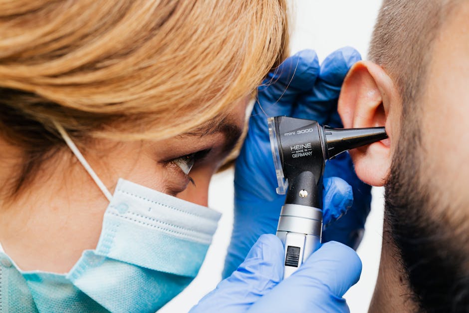 Doctor examining patient's ear with an otoscope — What Causes BPPV | Dr. Prateek Porwal, ENT